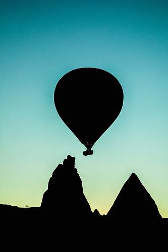 hot air balloon silhouette of hot air balloon flying above rock formation cappadocia